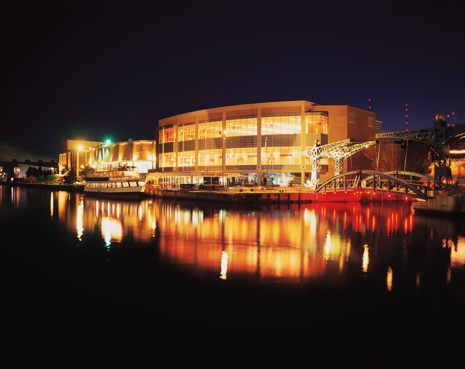 The Duluth Entertainment and Convention Center at night. It's lights reflect on the Harbor.