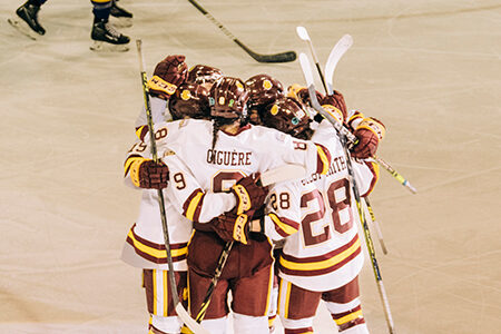 hokey team in a group huddle